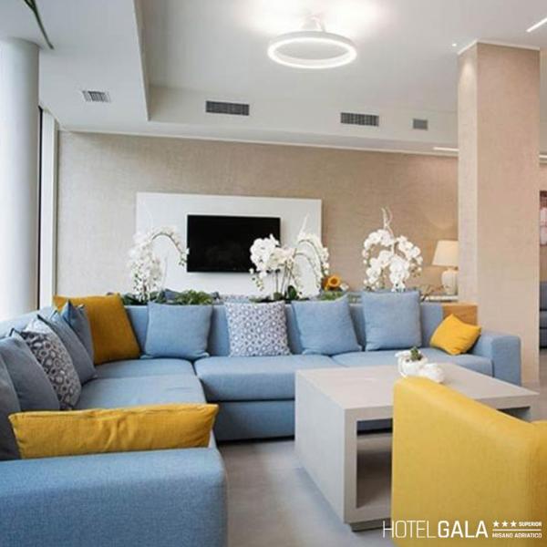 Modern living room with blue and yellow sofa, floral decorations.